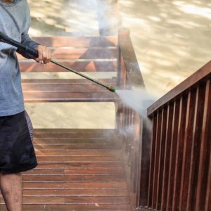 Professional power washing a deck